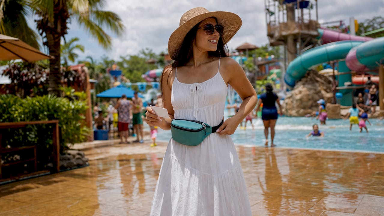 Woman wearing waterproof bag at water park entrance